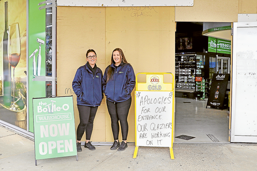 DOORS STILL OPEN… From left, Bottle-O Warehouse manager, Jacque Wayman and assistant manager, Shakeah Cleary are reminding locals that despite the shop front being damaged in a ram-raid recently, they are still open for business. Photo: Katelyn Morse.