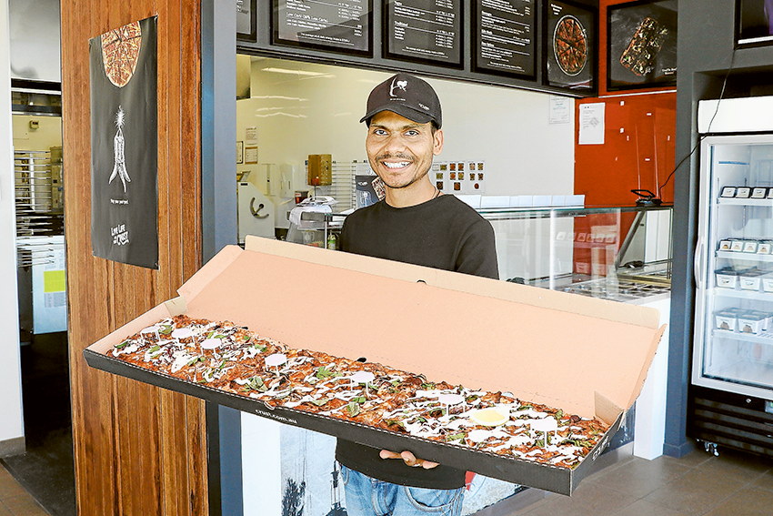 AN ENTIRE METER OF DELICIOUS PIZZA… Crust Shepparton franchisee, Girraj Tomar and one of their famous one-meter pizzas. Photo: Katelyn Morse.