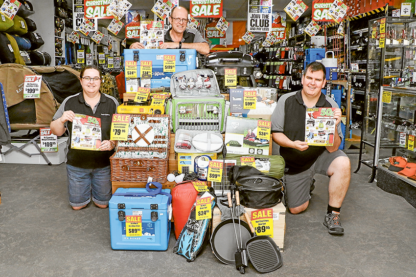 SEIZE A HOLIDAY HAUL… From left, Aussie Disposals Shepparton franchisee, Belinda Hurren, employee, David Harland and franchisee, Bernie Hurren with their decked out display of catalogue treats. Photo: Katelyn Morse.