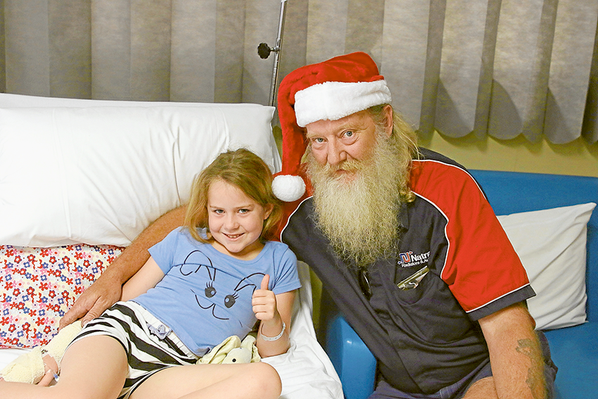 GENEROSITY TO HELP SICK KIDS… From left, local resident, 8-year-old Isabelle Waser and Paul Archer from Natrad. Photo: David Lee.