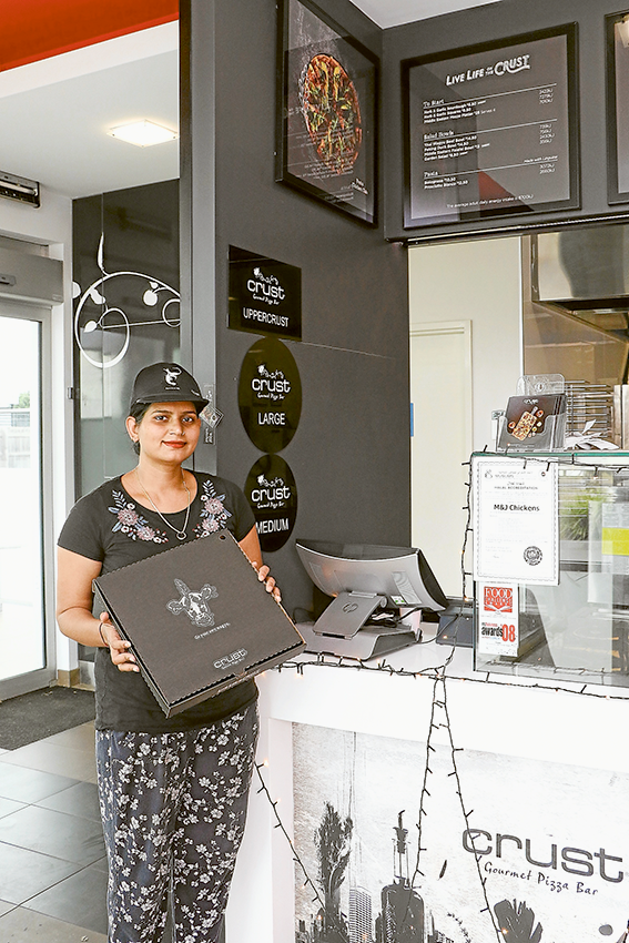 KIDS LOVE CRUST… Crust Shepparton team member, Shalini Shadauria is happily preparing pizzas and is in the spirit of giving to the community. Photo: Katelyn Morse.