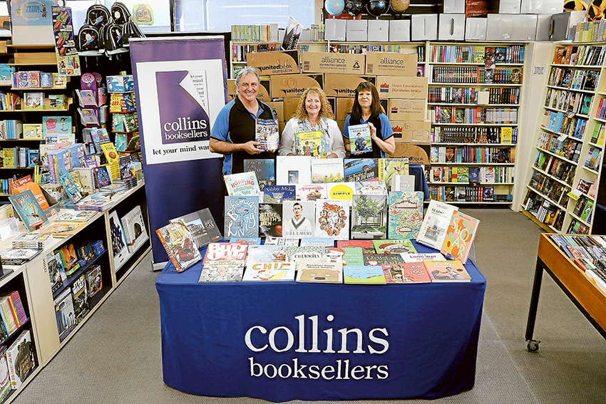 THREE R’S: READING, READING AND READING… From left, Shepparton Collins Booksellers co-owner, Joe Sofra, Collins Booksellers’ 2018 Christmas Reading Guide winner, Kerri Christie and Collins Booksellers co-owner, Helen Sofra showing off just a small smattering of Kerri’s winning collection. Photo: Ash Beks.