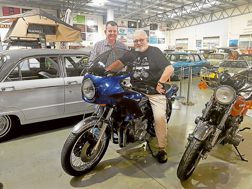TOUCH OF FAME… From left, Shepparton Motor Museum curator, Shaun Lennard with actor and creator of the bikes used in the Mad Max film, Bertrand Cadart during his visit to the region last week as part of a filming of his documentary, Beneath the Outback Sun. Photo: Supplied.