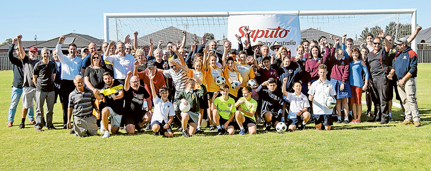 GIVING BACK TO COMMUNITY… Members of the Moira Shire Council, Cobram Roar Football Club, representatives of Saputo Dairy Australia and the local dairy farming community gathered at Cobram Apex Park recently to formally announce a $65,000 contribution by Saputo to go toward the construction of a Cobram Community Soccer Pavilion. Photo: Supplied.