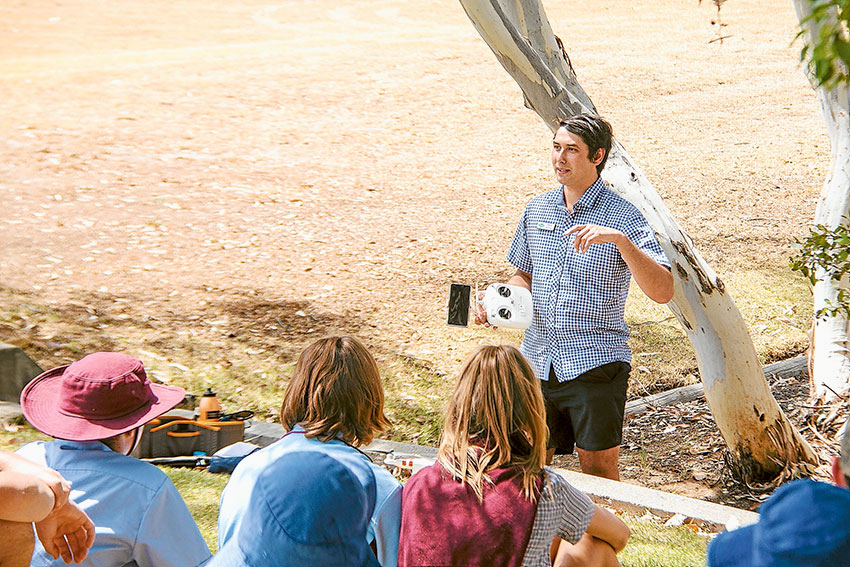 HANDS-ON LEARNING… Darcy Warren from FAR Australia demonstrates drones for agricultural management and research to local students at the University of Melbourne’s Dookie Campus. Photo: Supplied.