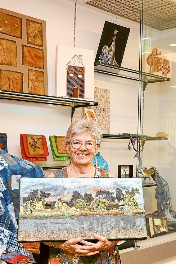 LET TEXTILES WOW YOU… Shepparton Textile Artists Inc president, Judith Roberts with a piece created by local resident, Barb Gray which was a part of last year’s A Good Yarn exhibit and workshops, which are coming up again this year. The piece, titled ‘The Lake,’ uses hand dyed fabric and hand made felt that is machine and dense hand stitched. Photo: Katelyn Morse.