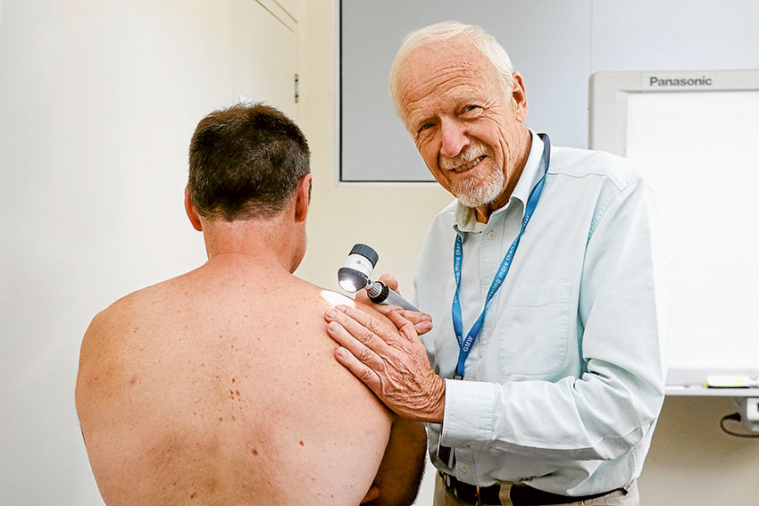 KEEPING STAFF HEALTHY AND HAPPY… Dr Peter Berger carrying out a skin cancer check on Goulburn-Murray Water staff member, Paul Bruce as part of the company’s health and wellbeing program. Photo: Katelyn Morse.