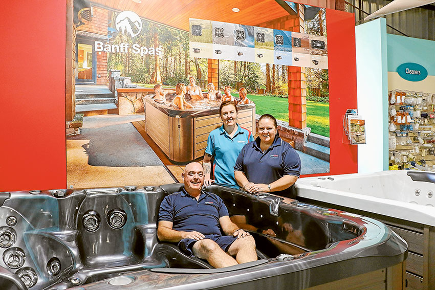 KEEP WARM IN THE SPA THIS WINTER… From left, Poolwerx co-owner, Craig Henry, retail manager, Row Thompson and co-owner, Rosie Henry are offering a huge sale on spas. Photo: Katelyn Morse.