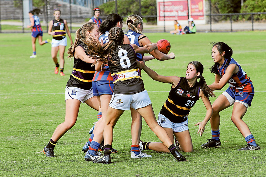 TACKLE PRESSURE… From left, Murray Bushrangers players, Kate Adams, Abby Favell and Ellie Mifka applying tackle pressure to the Oakleigh Chargers. Photo: Will Adams.