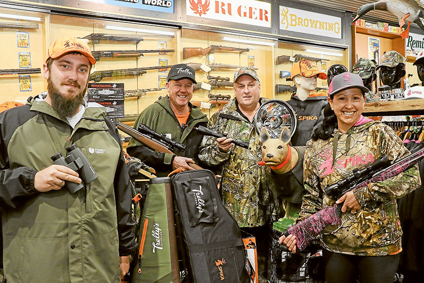 BARGAINS TARGETED… From left, Trelly’s Hunting and Fishing World team member, Brad Seiter, owner, Steve Threlfall, team member Rick Seiter and owner, Mary Threlfall are fully locked and loaded with stock as hunting season commences. Photo: Katelyn Morse.