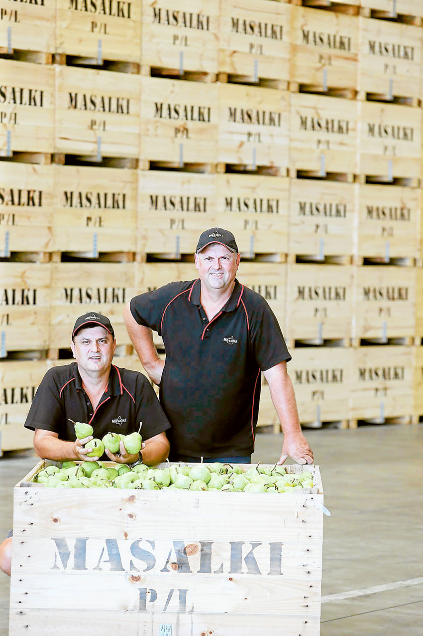 NEW GROUND-BREAKING TECHNOLOGY… Orchard co-owners, Con and Philip Damianopoulos in their apple and pear storage facility, Masalki, at Shepparton, which will save up to 80 percent in water usage thanks to receiving $400,000 in funding provided through the Coles Nurture Fund program. Photo: Supplied.