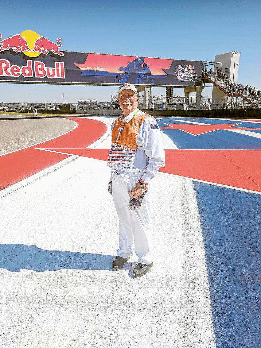 THE ROAR OF THE TRACK… Local resident, John Painter at turn 16 of the Circuit of the Americas, where he spent three days as a track marshal recently. Photo: Supplied.