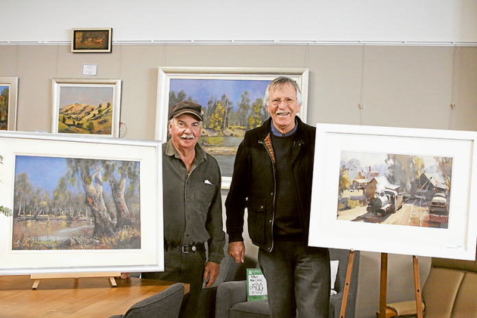 Accomplished artists reach the community… From left, local expert painters, Ray Hill and Ross Paterson are tutoring aspiring artists at the new art hub at Furniture Edition in Shepparton. Photo: Nicholise Garner.