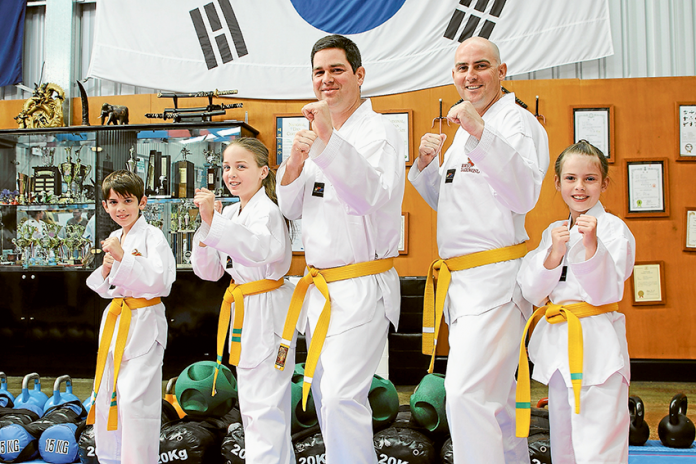 BUILDING ON SKILLS… From left, local residents and Koryo Taekwondo students, Lucas Buchan, 10, Olivia Buchan, 11, Brad Buchan, Martin Clark and Adalia Clark, 8, at the Koryo Sparring and Poomsae Competition 2018 on Sunday. Photo: Geoff Adams.