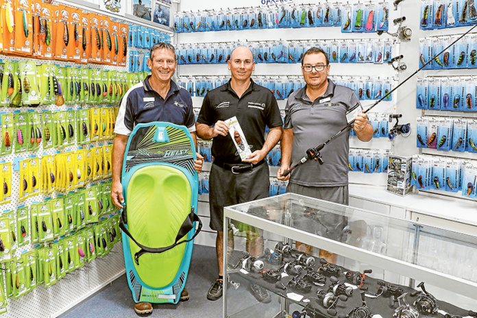 ADV---Boats-and-More WAY MORE THAN BOATS AND FISHING… From left, Boats & More retail manager, Mike Scandolera, owner, Simon Ryan and resident fishing guru, Terry Phillips showcasing their vast range of stock. Photo: Katelyn Morse.