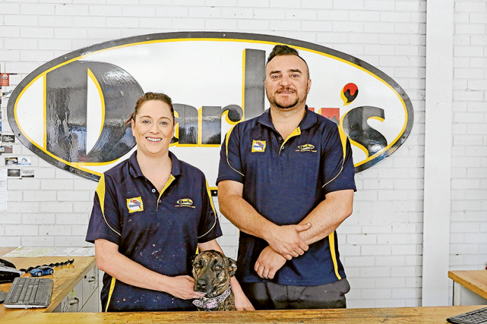 THE PAINT PROFESSIONALS… From left, Darby’s Paints Shepparton store manager, Megan Brown, store mascot, Molly and sales technician, Jarrod Hasan. Photo: Katelyn Morse.