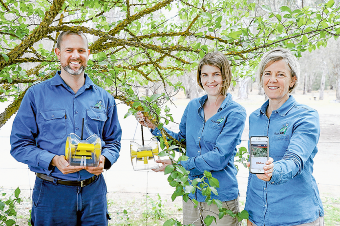 ED---CSIRO-new-fruit-fly-tech THE FIRST STEPS TO ERADICATION… From left, RapidAIM co-founders, Darren Moore, Laura Jones and Nancy Schellhorn with the new Queensland Fruit Fly detection trap. Photo: Katelyn Morse.