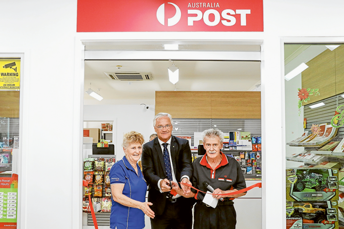 CELEBRATING AN OPENING… From left, Shepparton North Australia Post licensee, Diane Colbert, Federal Member for Murray, Hon Damian Drum and Shepparton North Australia Post licensee, Tom Colbert cut the ribbon to officially open the post office’s new location. Photo: Katelyn Morse.
