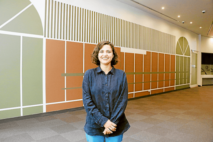 ED---SAM-Drawing-Wall-Esther A NEW PERSPECTIVE… Melbourne based artist, Esther Stewart in front of her work which is the 33rd installation of the SAM Drawing Wall. Her piece depicts a ‘flattened, to scale’ version of the 1980s bus shelter across from the Shepparton Visitor Information Centre. Photo: Katelyn Morse.