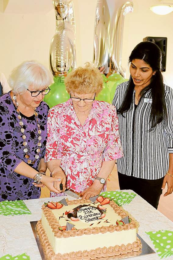 HAPPY 21st BIRTHDAY HARMONY VILLAGE… From left, Doutta Galla Aged Services CEO, Vanda Iaconese, Harmony Village resident of 21 years, Melek Seit and Harmony Village manager, Sandy Paily celebrate the occasion with a delicious cake. Photo: Supplied.