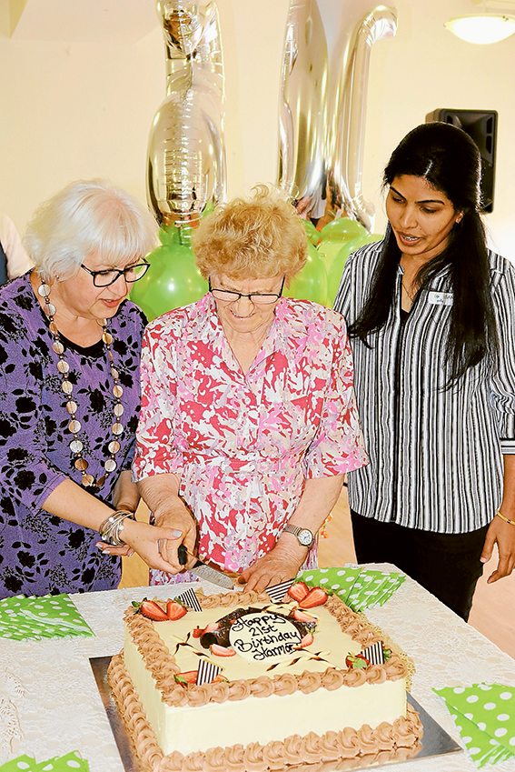 ADV---Harmony-Village HAPPY 21st BIRTHDAY HARMONY VILLAGE… From left, Doutta Galla Aged Services CEO, Vanda Iaconese, Harmony Village resident of 21 years, Melek Seit and Harmony Village manager, Sandy Paily celebrate the occasion with a delicious cake. Photo: Supplied.