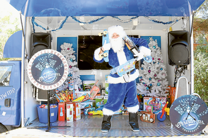 WIN CHRISTMAS GOODIES… Blue Santa inside the Shepparton Show Me Thompson Kia mobile stage, which is giving locals the chance to win great Christmas prizes. Photo: David Lee.