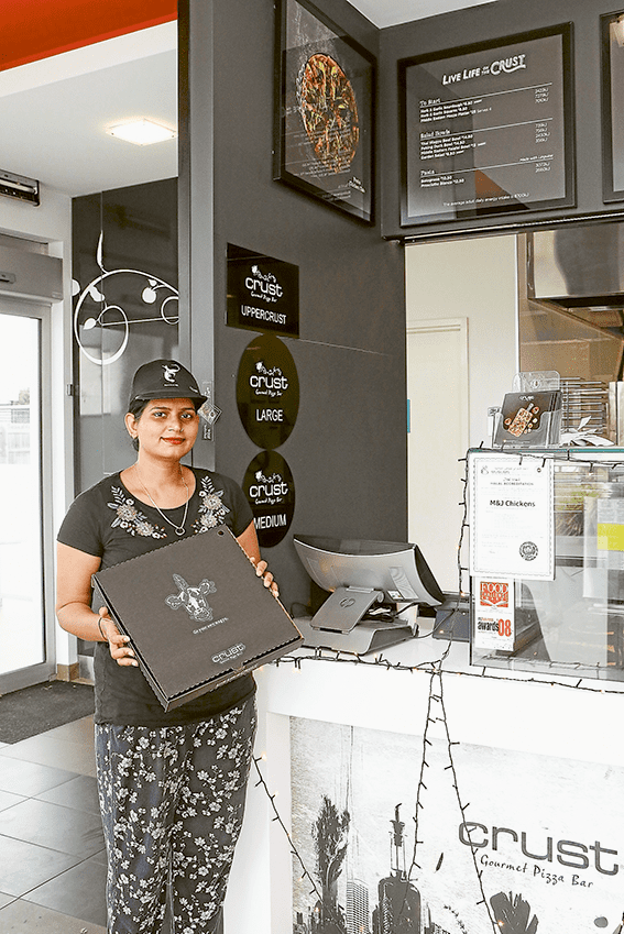 KIDS LOVE CRUST… Crust Shepparton team member, Shalini Shadauria is happily preparing pizzas and is in the spirit of giving to the community. Photo: Katelyn Morse.