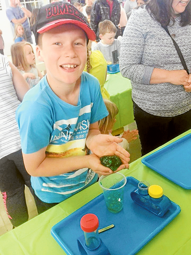 SCHOOL HOLIDAY FUN… Eight-year-old, Ethan Montgomery having fun with the slime activities at Riverside Plaza. Photo: Supplied.