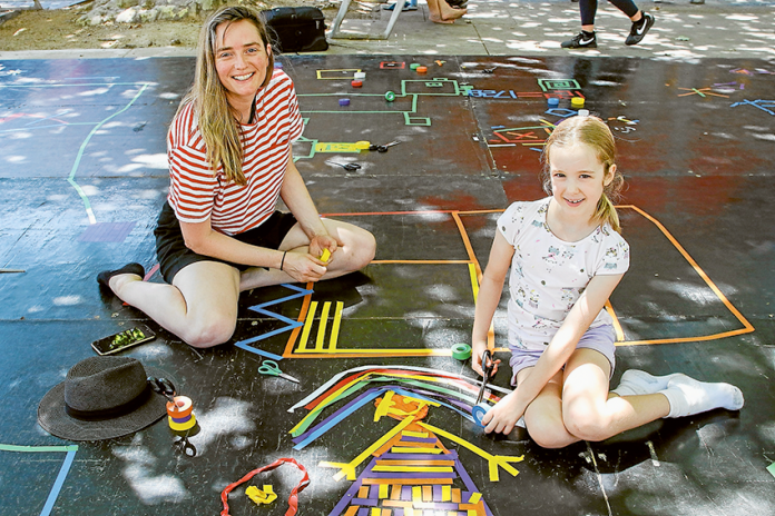 COLOURFUL ART… Artist, Briony Barr collaboratively creating with young artist and Kialla resident, Molly Chambers, 6. Photo: Katelyn Morse.