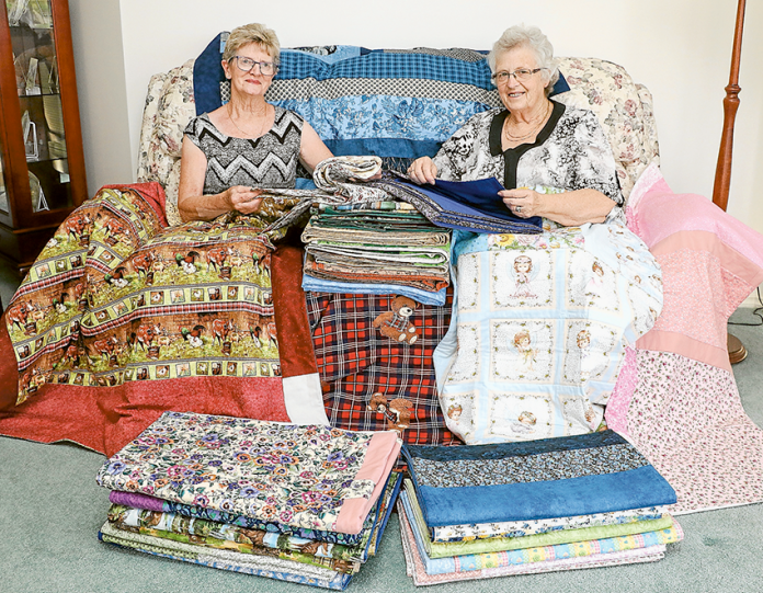 QUILT DONATION FOR CANCER PATIENTS… From left, Shepparton Granelen Hardanger Group members, Jan Delahey and Jan Gough. Photo: Katelyn Morse.