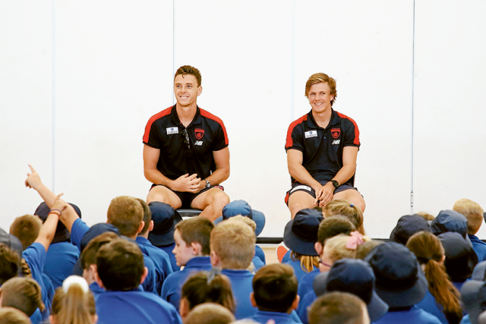 DEMONS HOST SUPER CLINICS… From left, Melbourne Football Club players, Jake Leaver and James Jordan taking questions from students at Guthrie Street Primary School during a special visit last week as part of the club’s country visit. Photo: David Lee.