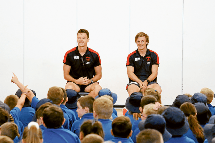 SPORT---Melb-FC-visit DEMONS HOST SUPER CLINICS… From left, Melbourne Football Club players, Jake Leaver and James Jordan taking questions from students at Guthrie Street Primary School during a special visit last week as part of the club’s country visit. Photo: David Lee.