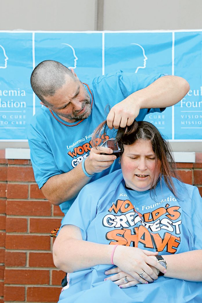 THE BIG SHAVE… Local Tatura man, Brian Cocomazzo shaving the hair of Kyabram resident, Stacy Cavill-Wheeler for the World’s Greatest Shave event last week. Photo: Melanie Spencer.