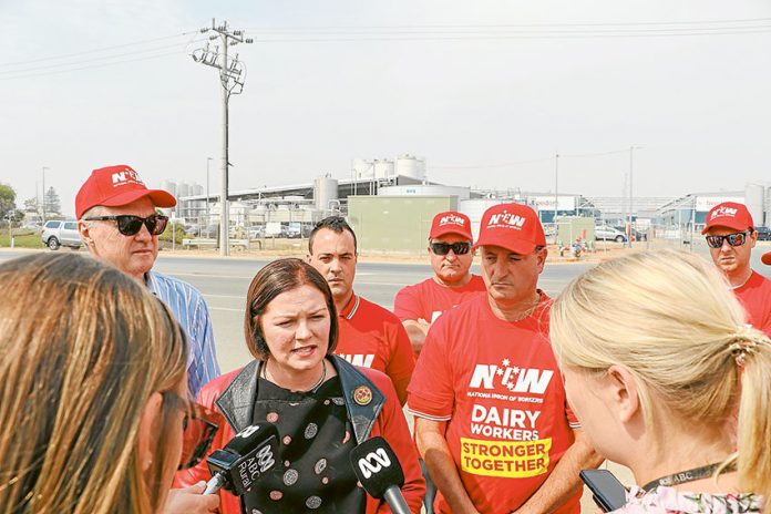 WHO IS TELLING THE TRUTH?… From left (front), Labor Candidate for the seat of Murray (Nicholls), Bill Lodwick, Shadow Assistant Minister for Workplace Relations, Lisa Chesters, National Union of Workers (NUW) site organiser, Thomas Czech and NUW lead dairy organiser for Victoria, Neil Smith with local dairy processing workers (back) at a media doorstop last week where the union claimed that migrant workers at the Shepparton Freedom Foods plant are being exploited. Photo: Katelyn Morse.