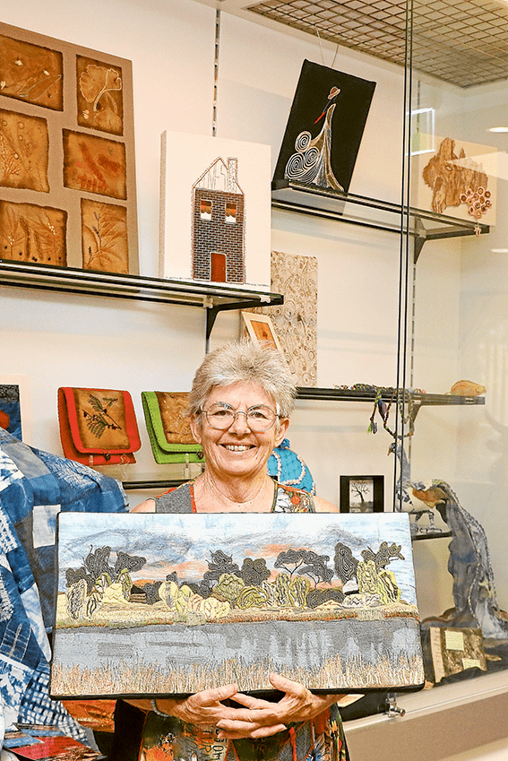 LET TEXTILES WOW YOU… Shepparton Textile Artists Inc president, Judith Roberts with a piece created by local resident, Barb Gray which was a part of last year’s A Good Yarn exhibit and workshops, which are coming up again this year. The piece, titled ‘The Lake,’ uses hand dyed fabric and hand made felt that is machine and dense hand stitched. Photo: Katelyn Morse.