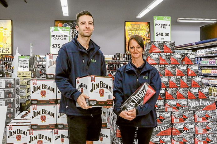 BOTTLE UP A BARGAIN… From left, Bottle-O Warehouse assistant manager, Jamie Spencer and store attendant, Karen Fitzgerald are enthusiastic to help customers get all they need these Easter holidays. Photo: Katelyn Morse.