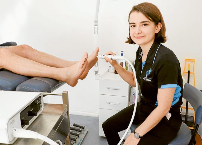 TECHNOLOGICAL STEPS FORWARD… Lakeside Podiatry would like to welcome new podiatrist, Marissa Nicolacopoulos to the clinic, seen here working with the SWIFT microwave wart technology, a first for the region. Photo: Katelyn Morse.