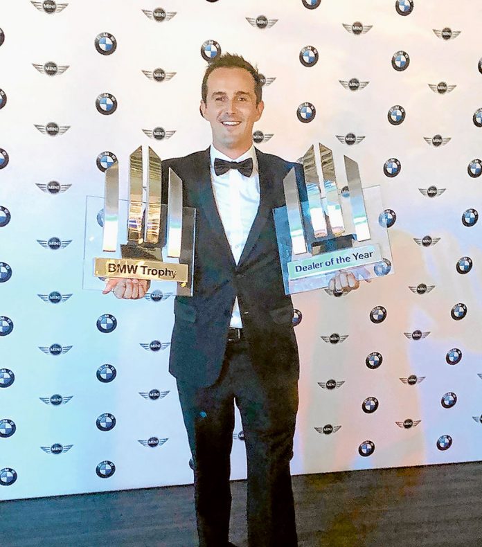 AWARD WINNING SMILES… Shepparton BMW dealer principal, Aaron Brain with the 2018 Rural Dealer of the Year and 2018 National Dealership of the Year trophies awarded to the dealership recently. Photo: Supplied.