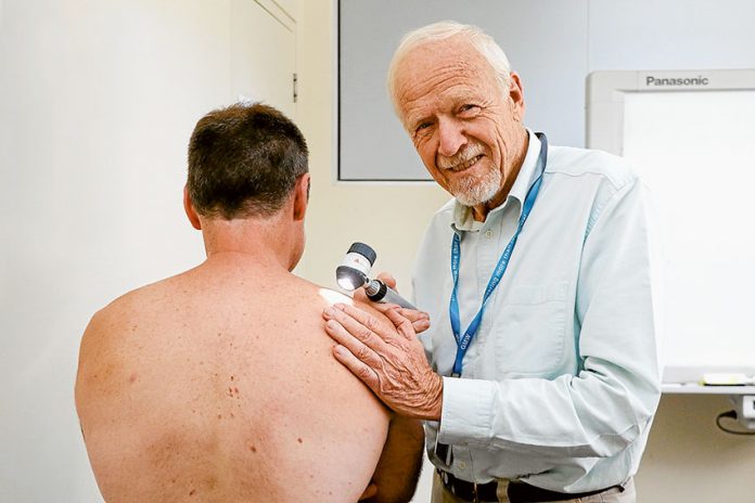 ED---GMW-skin-checks KEEPING STAFF HEALTHY AND HAPPY… Dr Peter Berger carrying out a skin cancer check on Goulburn-Murray Water staff member, Paul Bruce as part of the company’s health and wellbeing program. Photo: Katelyn Morse.