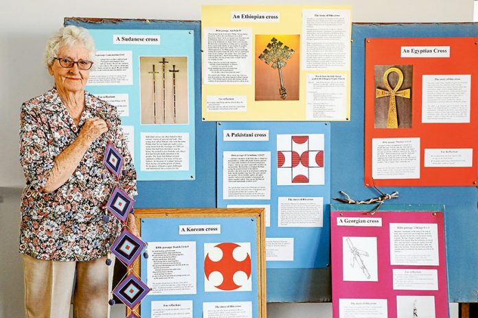MASSES OF CROSSES… Joan McRae from Shepparton Uniting Church holding the Latin America (God’s Eye) Cross, which is one of 31 crosses on exhibition at the church. Photo: Katelyn Morse.