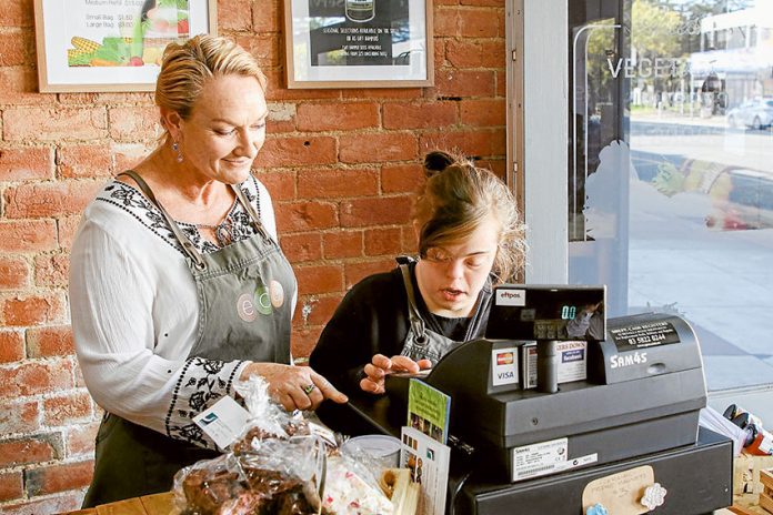 HEALTH---NDIS-main-story ENABLING THE WHOLE COMMUNITY… From left, Yvette Knight helping Justine McCartney learn new skills. Photo: David Lee.