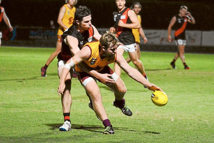 PLAYING UNDER THE LIGHTS… From left, Aaron Hayes (Kyabram) and Mitchell Brett (Shepparton Bears) playing under the lights during a night game. Photo: Bailey Opie Photography.