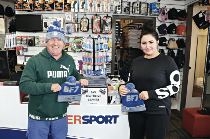 HELP FIGHT MND… Intersport Shepparton owner, Gary Harvey and sales assistant, Steph, with the beanies. Photo: Stephanie Holliday