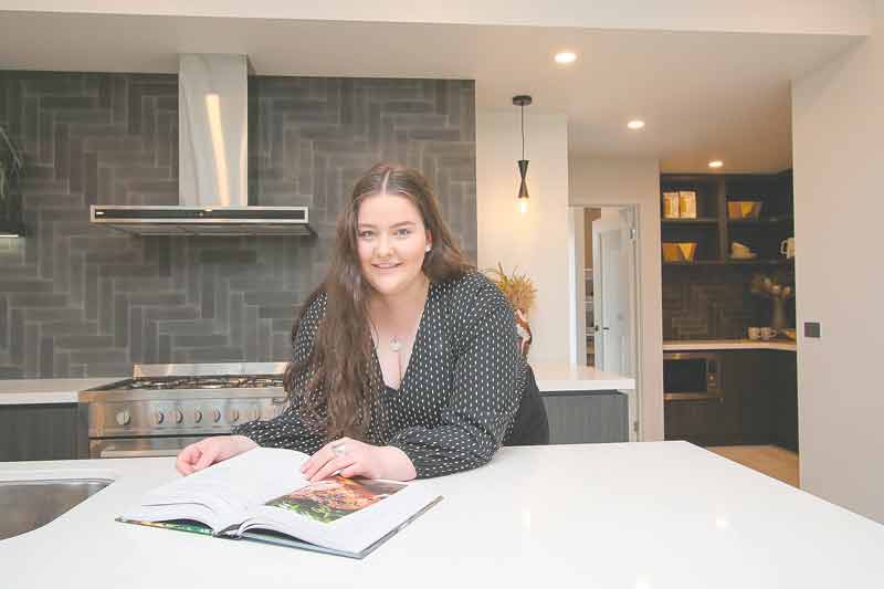 DESIGN FROM HOME... Using an online tool, you can design your dream home. Pictured is Simonds Homes sales cadet, Sinead Simkin in one of the beautiful homes on display in Kialla. Photo: Kelly Lucas