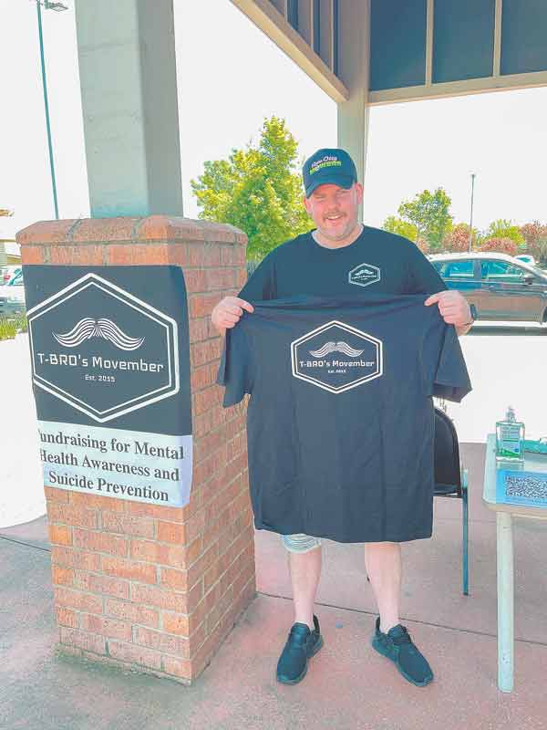 T-BRO ROCKIN’ THE MO... Tyler Brodie outside of Woolworths in Benalla selling raffle tickets and merchandise to raise funds for men’s mental health. Photo: Supplied