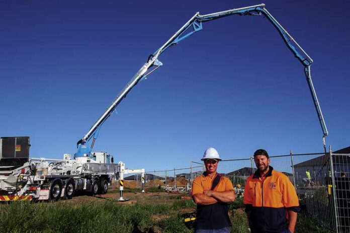 ED---PJS-CONCRETE-PUMPING-1 BOOM THANKS TO RESIDENTIAL BUILDS... Pump operator David Tomkins with PJ’s Concrete Pumping manager, Keelan Don. Photo: Kelly Lucas.