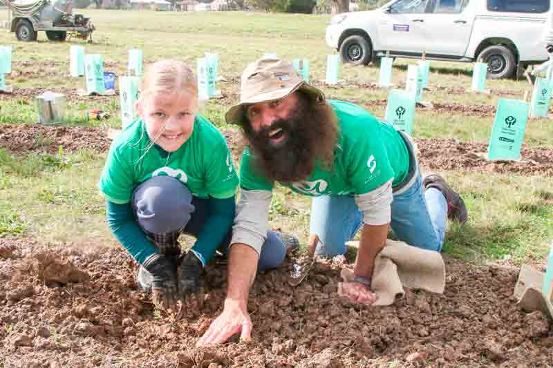 BIG ACHIEVEMENT... Local student, Amelia Parsons planting trees with Costa Georgiadis from ABC’s Gardening Australia in Shepparton on Friday. Photo: Deanne Jeffers.