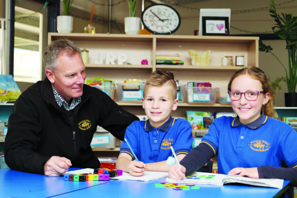 WORKING HARD BEHIND THE SCENES...Kialla West Primary school principal, Wes Teague with grade two students James Wood and Angelina Tassoni.  Photo: Kelly Carmody