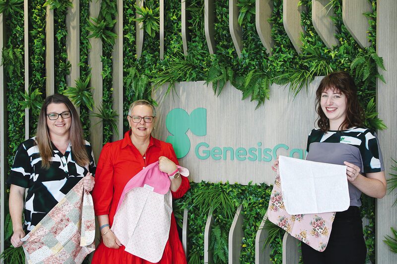 PROVIDING A LITTLE DIGNITY AND A WHOLE LOT OF CARE...Pictured from left, GenesisCare patient services officer Allison Elliot, retired aged care worker and mother of two, Olinda and GenesisCare radiation therapist Erin Johnson proudly display the small but meaningful modesty covers. Photo: Natasha Fujimoto
